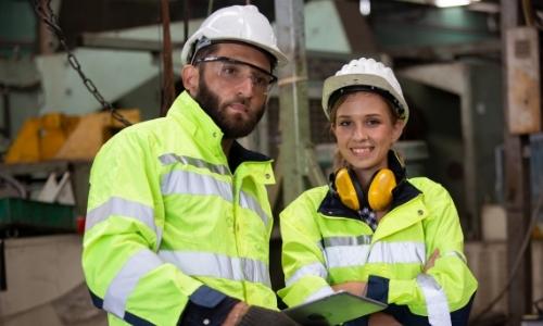 Male and female engineers in a factory