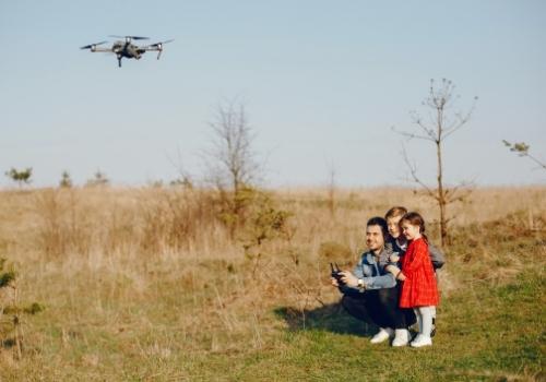 Father and children flying a drone