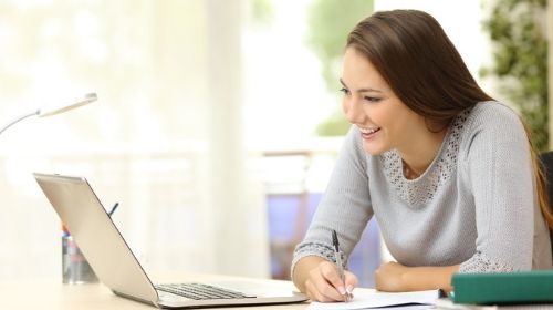 Teacher looking at research findings on laptop