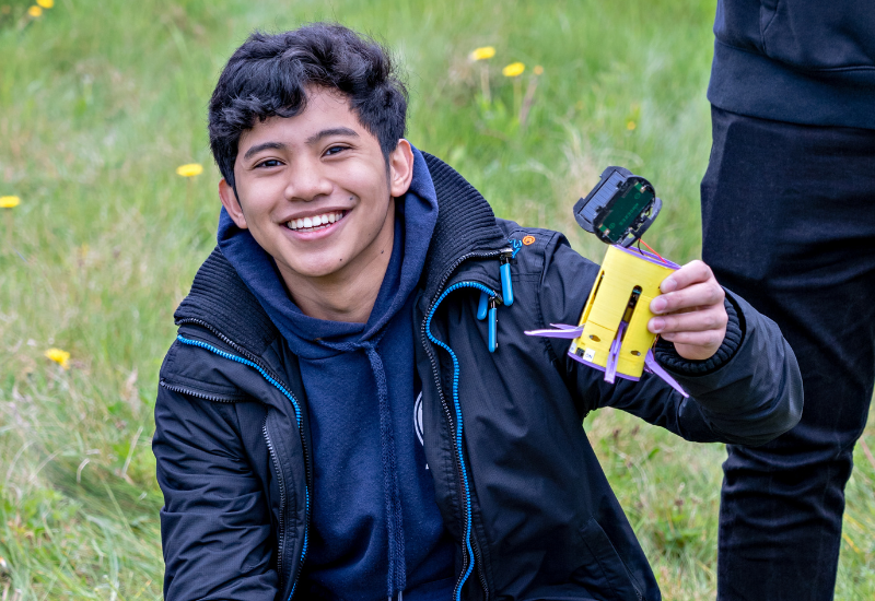 Student holding a CanSat